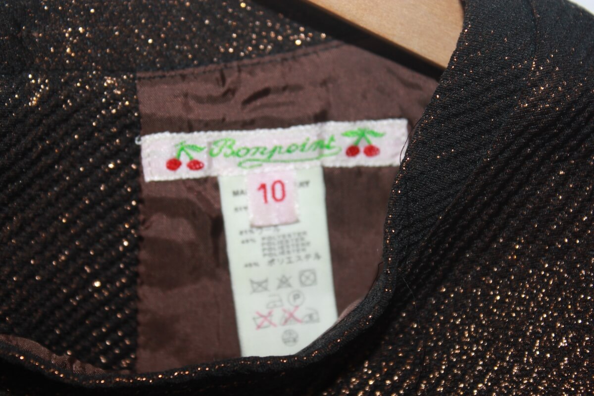 Tweedehands koperkleurige feestelijke jurk met glitters en korte mouwen van bonpoint in maat 134-140