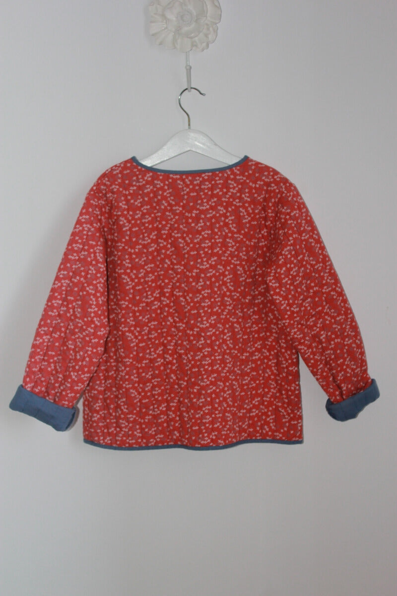 tweedehands katoenen rood met ecru en blauw gebloemd jasje van gocco ,voor het tussenseizoen, in maat 134-140 voor een meisje