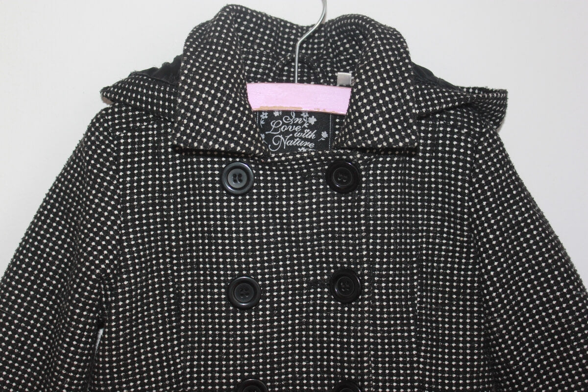 tweedehands zwarte jas met ecru stipjes en capuchon in maat 98 voor een meisje van palomino