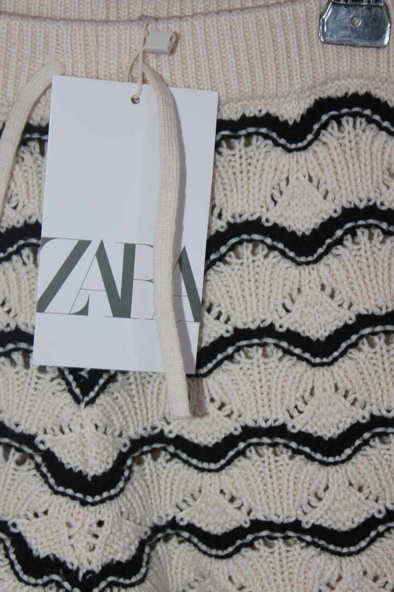 Tweedehands creme met zwarte gebreide korte broek in maat 116 voor een meisje van zara